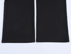 Detailed view of the hem stitching on black wide leg trousers with premium smooth fabric