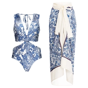 Detail of blue and white floral bikini with ruffled trim and matching wrap skirt set