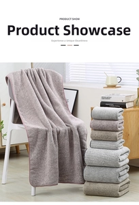 Detailed view of thick bamboo charcoal coral fleece towel set hanging on a chair