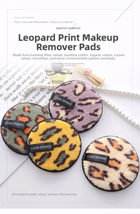 Macro shot of microfiber leopard print makeup pads with clean sponge ribbon handles