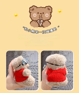 Close-up of brown teddy bear plush keychain wearing red sweater and trendy goggles