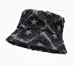 Detailed close-up of frayed star patch and distressed denim texture on bucket hat