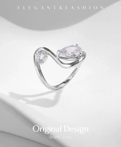 Macro shot of s925 silver ring featuring elegant pear and round shaped sparkling diamonds
