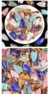 Detailed close-up of heart-shaped natural stone pendants with gold metal bails in various colors