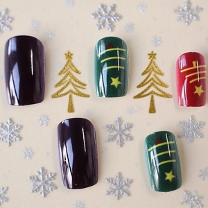 Christmas press-on nails with dark purple and festive tree patterns in medium square shape