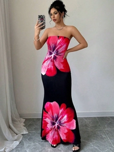 Dettaglio dell'elegante abito lungo a fascia nero con stampe floreali rosse vivaci