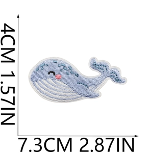Detailed view of blue whale embroidery patch with measurements 7.3cm x 4.0cm