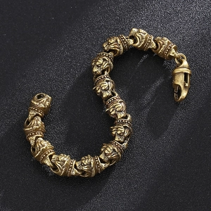 Detailed view of vintage bronze tiger head links with distressed metal texture on bracelet