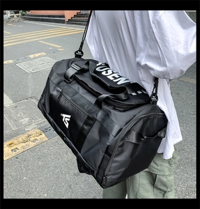 Outdoor shot of a black Oxford fabric multifunctional travel bag with shoulder straps