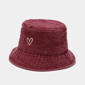 Close-up of heart embroidery on washed cotton bucket hat with metallic eyelets
