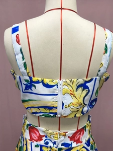 Detailed back view of a two-piece floral print set featuring a white zipper closure