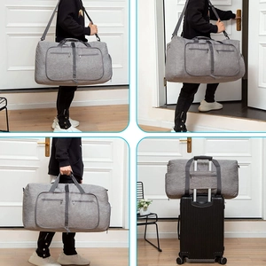 Gray foldable travel duffel bag showing shoulder carry and suitcase trolley sleeve usage