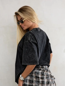 Detail of vintage washed black cotton oversized t-shirt showing fabric texture and fit
