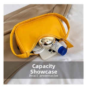 Internal view of yellow crescent shoulder bag showing storage capacity for phone and cosmetics