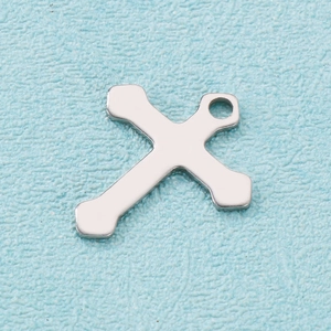 Close-up of polished silver stainless steel cross pendant with top loop for jewelry making