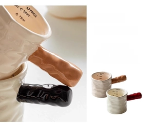 Detailed view of white ceramic milk pitcher with colorful handles and internal scale markings