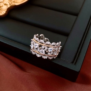Macro detail of luxury hollow-out silver ring with gold lines and pavé-set zircons