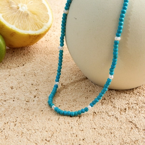 18K gold stainless steel necklace with turquoise beads and pearls on beige sphere