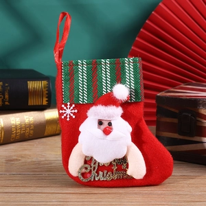 Detail of red felt Christmas stocking with 3D Santa, snowflake, and gold Merry Christmas sign