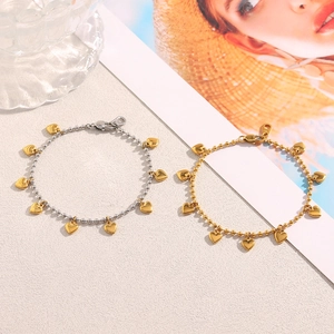 Detail of 18K gold-plated beaded heart pendant bracelets in gold and two-tone finishes