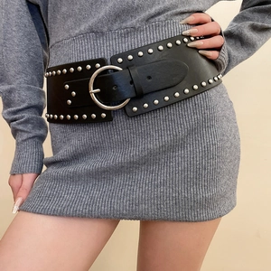 Detail of a wide black leather belt with silver rivets and large round metal buckle
