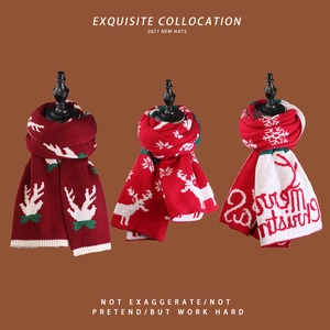 Detailed knit of Christmas scarves featuring reindeer patterns and festive holiday lettering