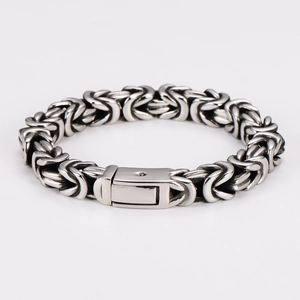 Detailed close-up of Byzantine weave stainless steel bracelet with polished clasp
