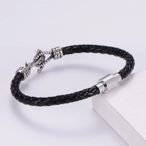Classic woven black leather bracelet for men with silver magnetic clasp on white stand