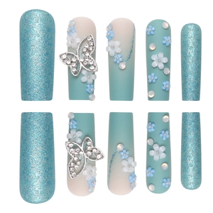 Long coffin fake nails with blue gradient, matte finish, 3D butterfly, and flower charms