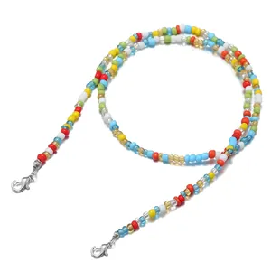 Detail of colorful seed bead eyewear strap with silver lobster clasps on white background