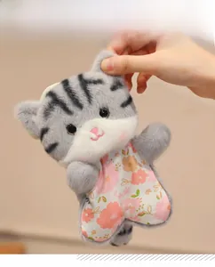 Detail of grey tabby cat plush toy wearing a cute floral dress with soft faux fur texture