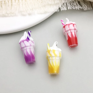 Close-up of resin mini drink charms with cream and straws in purple, yellow, and red