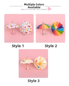 Detailed view of colorful mini dollhouse umbrella pendants with pearls and gold handles