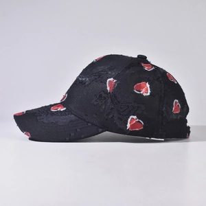 Distressed black baseball cap with red and white embroidered hearts and side logo