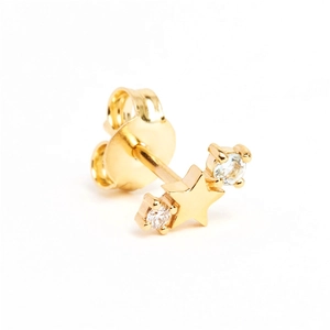 Macro detail of star shaped gold stud earring featuring side set sparkling zircons