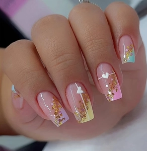 Detailed close-up of heart nail charms with gold foil and macaron gradient finish