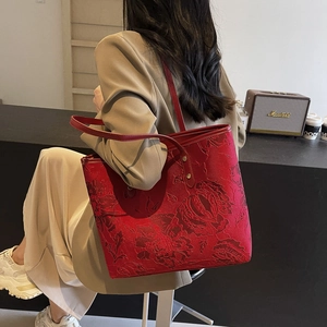 Red houndstooth tote bag with floral texture shown in a casual lifestyle setting