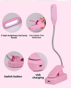 Detail view of pink LED clip lamp showing flexible neck, USB port, and power switch button