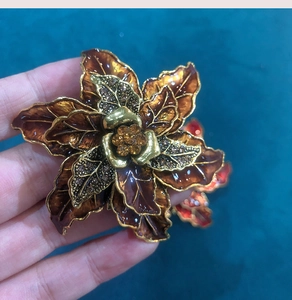 Detailed macro shot of vintage flower brooch with brown enamel and sparkling rhinestones