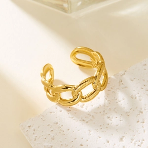 Detailed close-up of golden chain-style open ring with polished irregular geometric texture