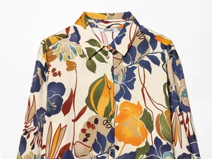 Close-up of vibrant floral print shirt with silky texture and sharp collar detail