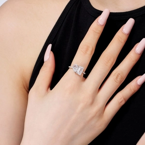 Detailed view of S925 silver ring featuring pear and emerald cut zircon stones on hand