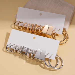 Detailed view of assorted gold and silver geometric hoop earrings on display cards