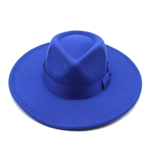 Detail of royal blue wool fedora hat with matching satin ribbon and wide brim texture