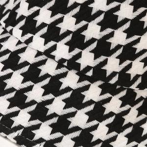 Detail shot of the thick houndstooth fabric texture and pattern on this winter bucket hat