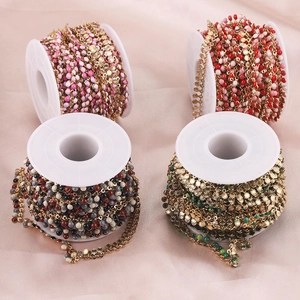 Colorful enamel bead and gold stainless steel jewelry chains on spools for DIY making