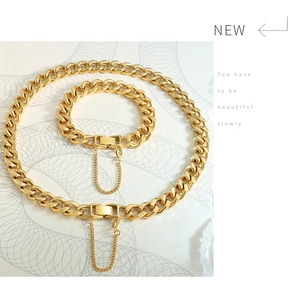 Detailed close-up of a chunky golden Cuban link necklace and bracelet jewelry set
