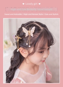Close-up of butterfly hair clips with pearl tassels and rhinestones for girls