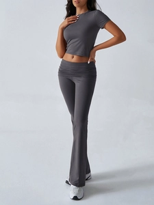 Detail view of women's dark grey yoga set with slim fit short sleeve top and flare pants