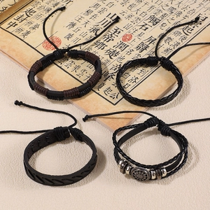 Retro multi-layer woven leather bracelet set in black and brown on vintage paper